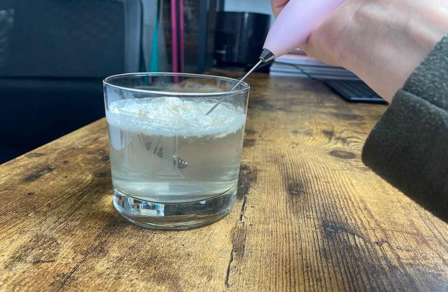 Our tester using a mini stirrer to blend up their serving of Primal Kitchen Collagen Peptides