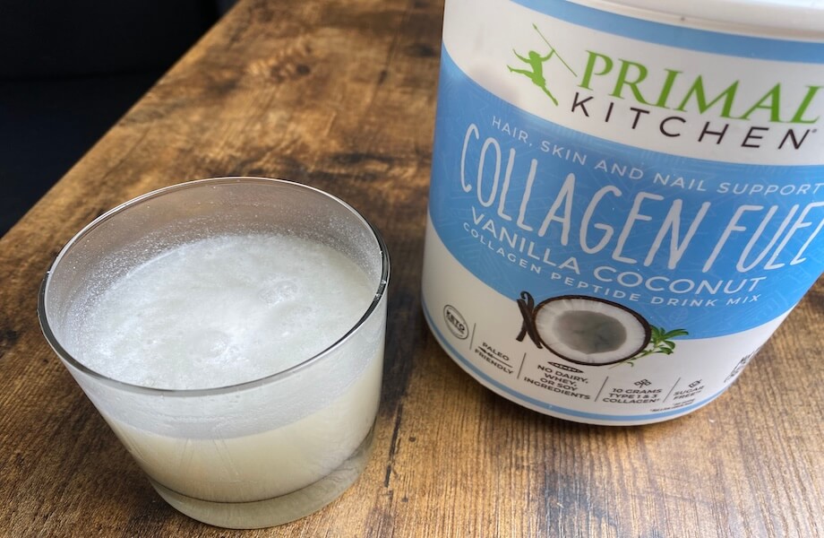 A container of Primal Kitchen Collagen Peptides next to a single serving