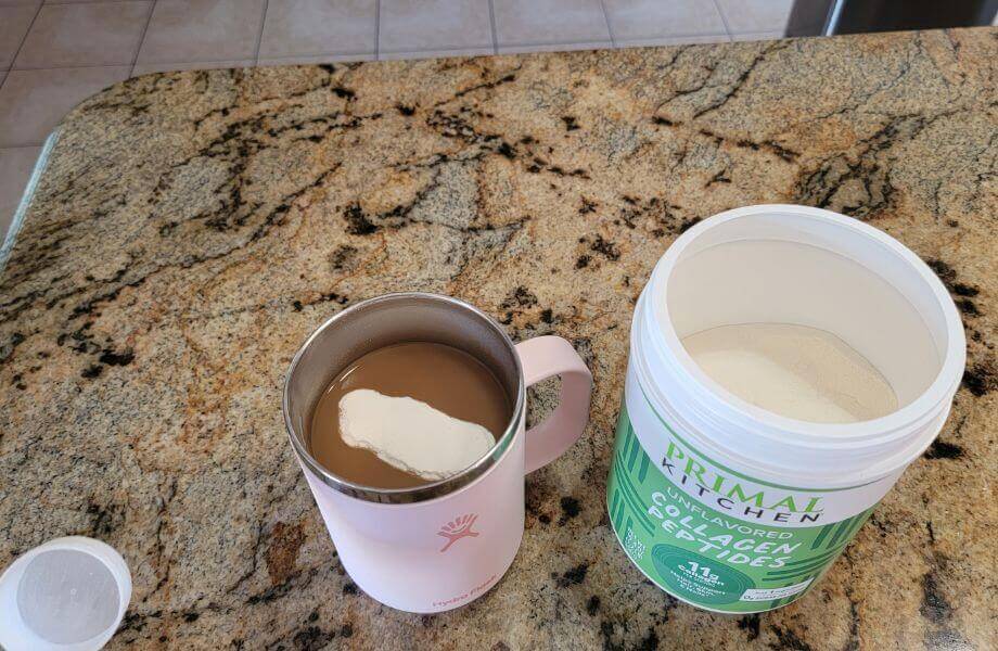 Primal Kitchen Collagen Peptides poured into a cup of coffee