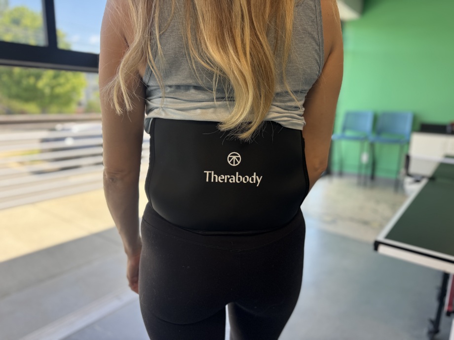 Rear view of a person wearing a Therabody Thermback LED