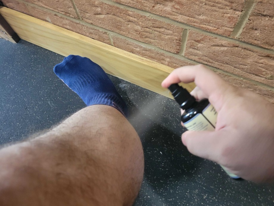 Spraying Cymbiotika Topical Magnesium Oil