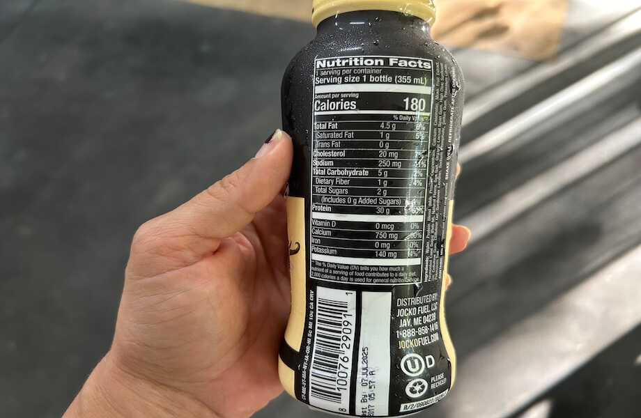 Our tester reading the nutrition facts of Jocko Molk Protein Shake