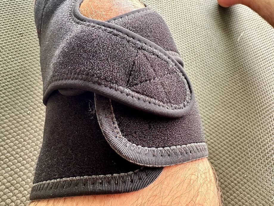 Overlapping patella straps of a McDavid Versatile Knee Wrap on a person's leg