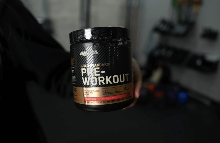 Our tester holding a container of Optimum Nutrition Gold Standard Pre-Workout