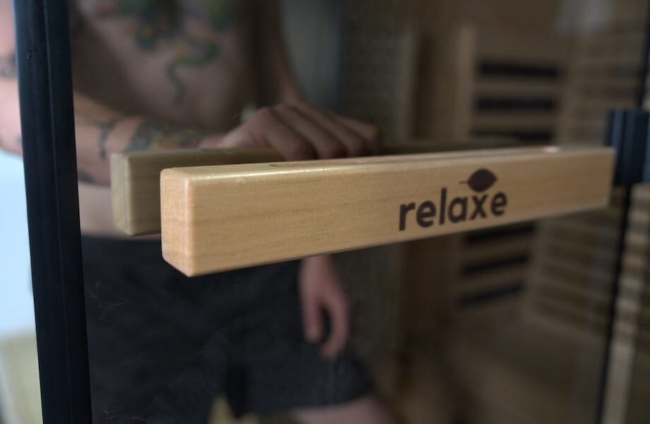 Our tester opening the clear glass door of the Relaxe Caldera Infrared Sauna