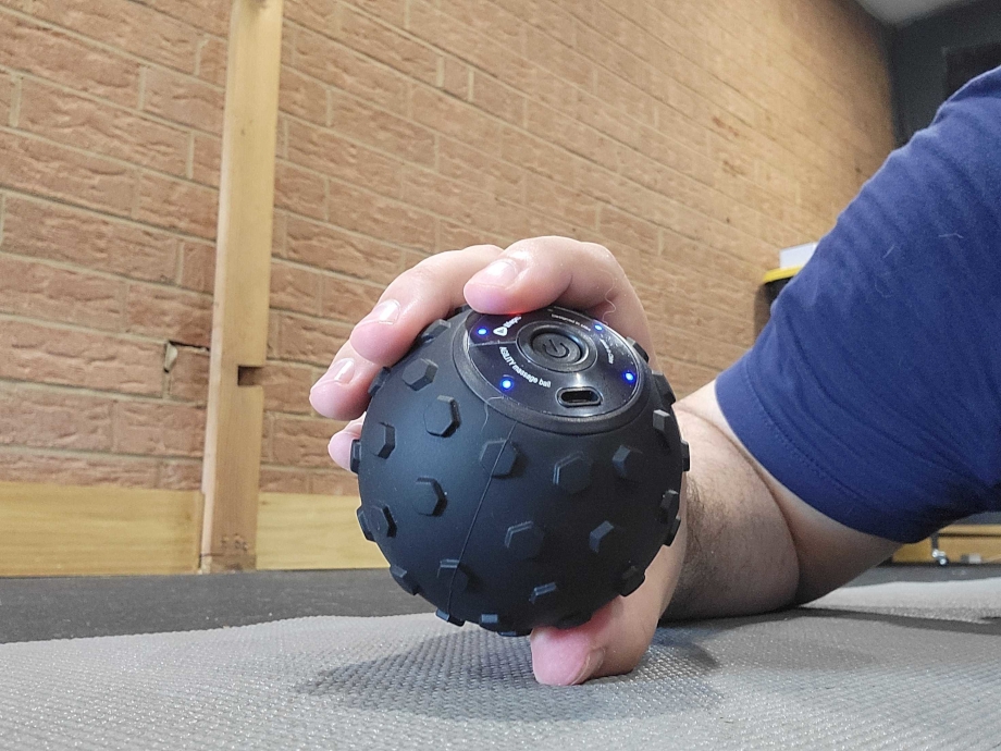 Our tester holding the LifePro Agility Vibrating massage ball in one hand
