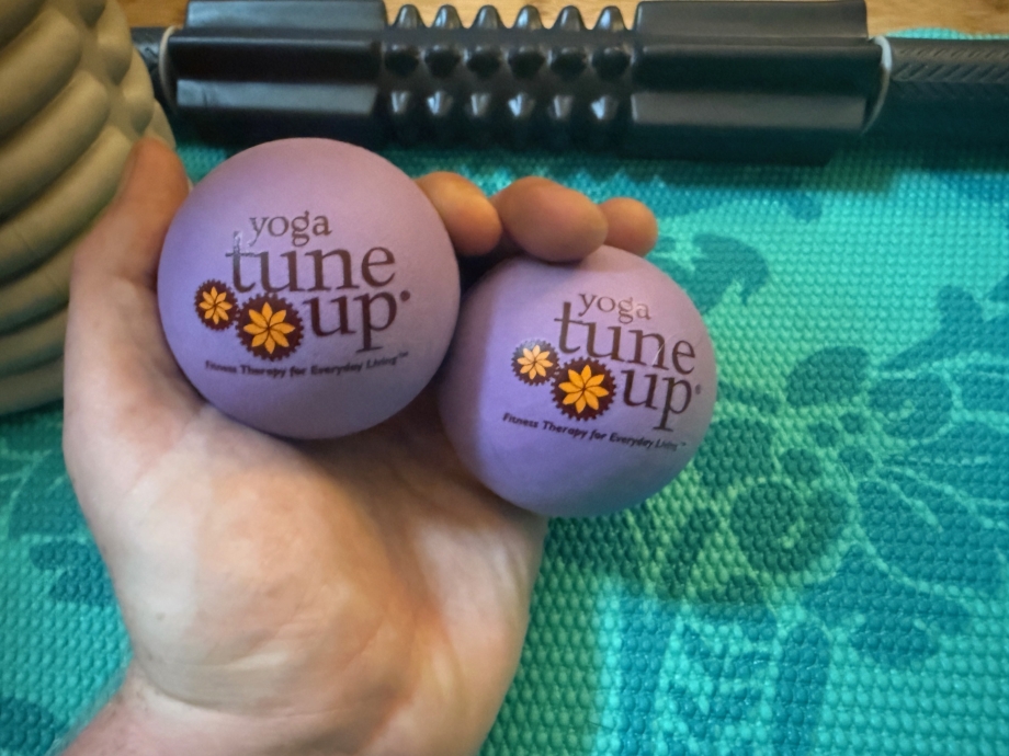 Our tester holding two Yoga Tune-up massage ball in one hand