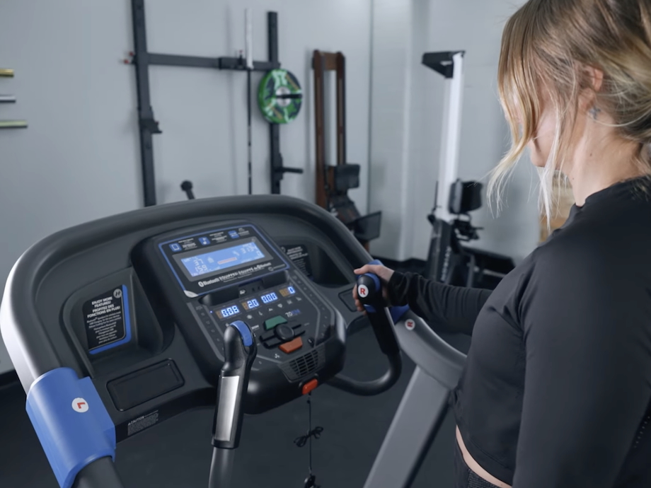 Product tester looking at the console on the Horizon 7.0 AT treadmill