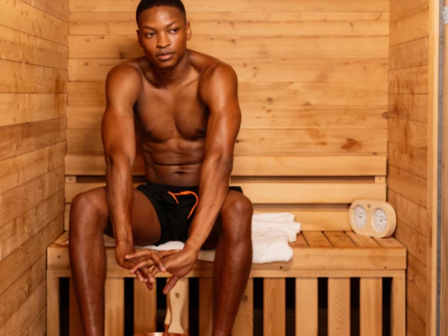 A man sitting in the Redwood Outdoors Duo Sauna