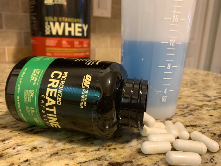 Bottle of Optimum Nutrition Creatine Pills laying on its side on the counter
