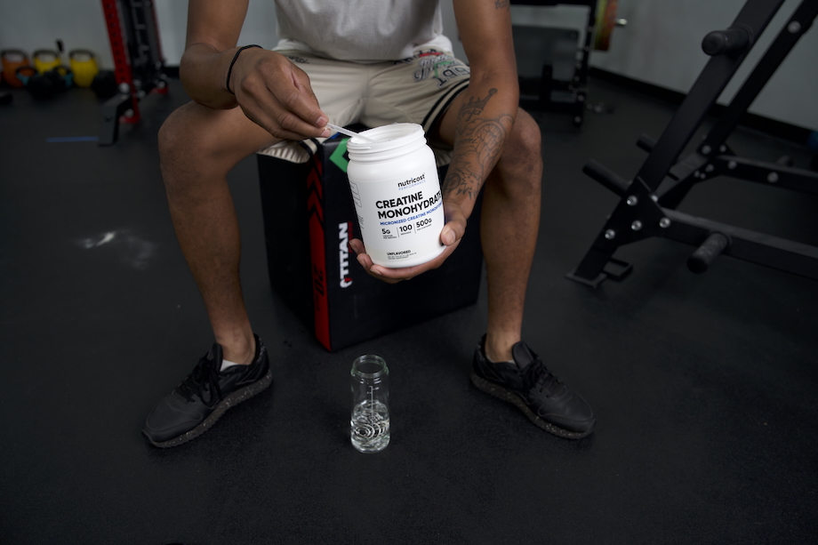 Product tester scooping out a serving of Nutricost Creatine