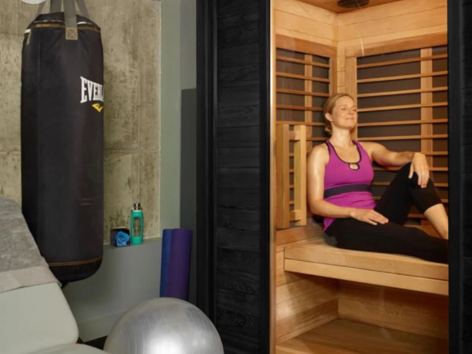 A woman sitting inside the Sun Home Equinox Infrared Sauna