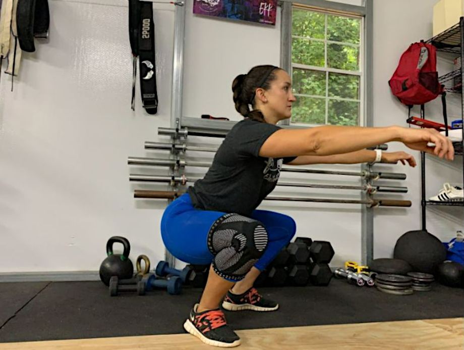 woman squatting with neenca knee sleeves
