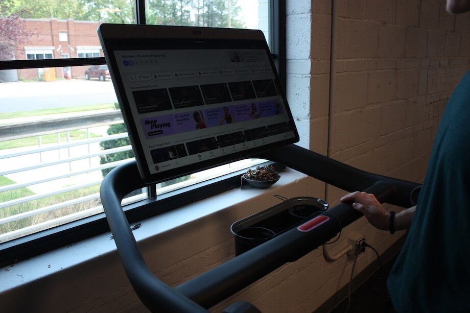 A product tester explores the classes available on the Peloton Tread