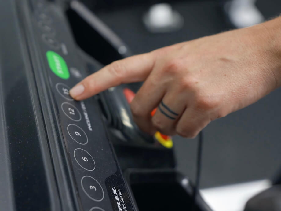 Product tester adjusting the incline settings on the Bowflex Treadmill 10