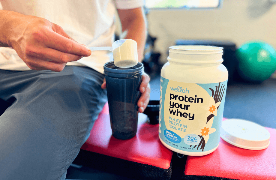 Our tester pouring a scoop of Wellah Protein Your Whey into their shaker bottle post-workout