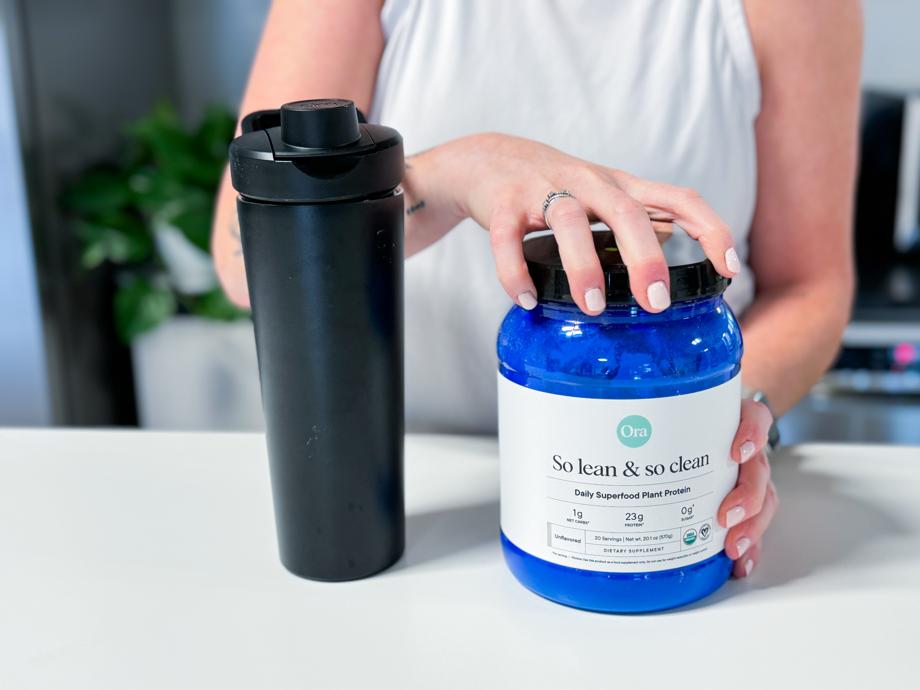 Opening a tub of Ora Organics So lean & so clean Plant Based Superfood Protein