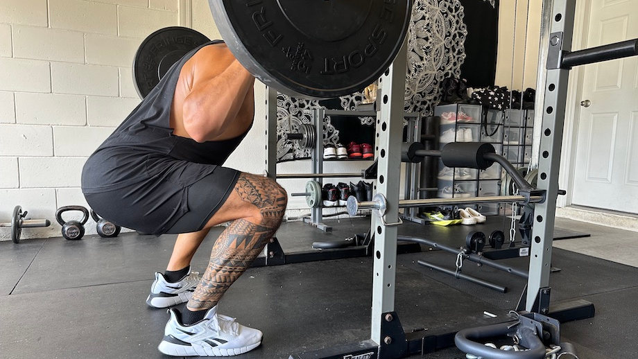 A man squatting in the Reebok Nano Gym Shoes