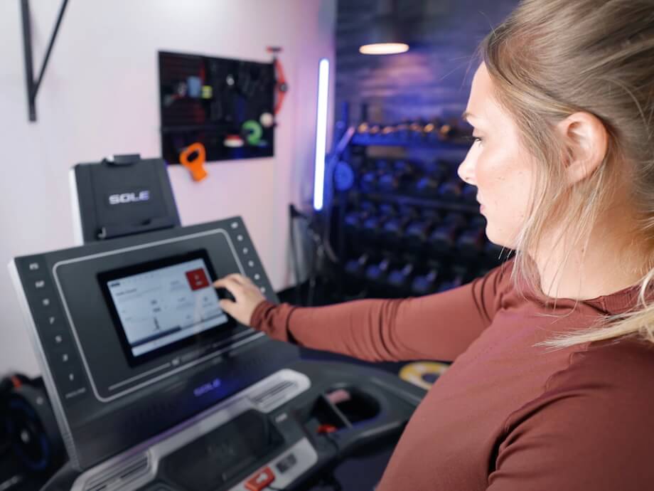 GGR Everything lead reviewer Lindsay Scheele using the touchscreen display on the Sole F80 treadmill