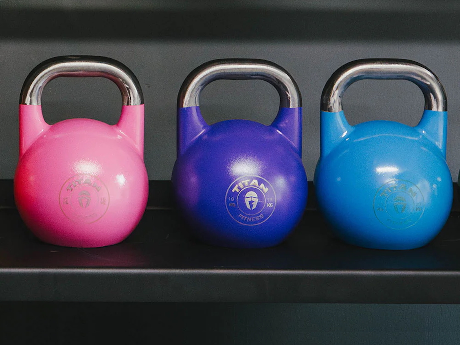 Multiple Titan Fitness Competition Style Kettlebells lined up next to each other