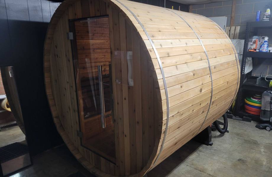 exterior view of almost heaven morgan barrel sauna located inside a garage