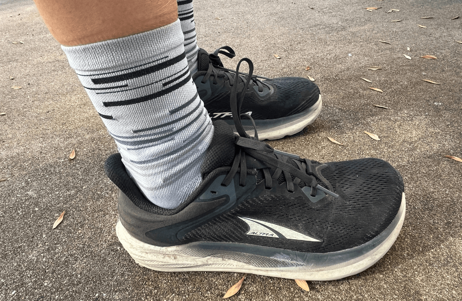 Our tester showing off the upper design of the Altra Torin 8 running shoes