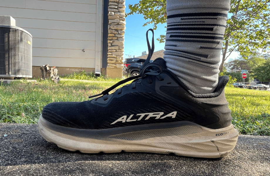 Our tester standing in their driveway with a pair of Altra Torin 8 running shoes