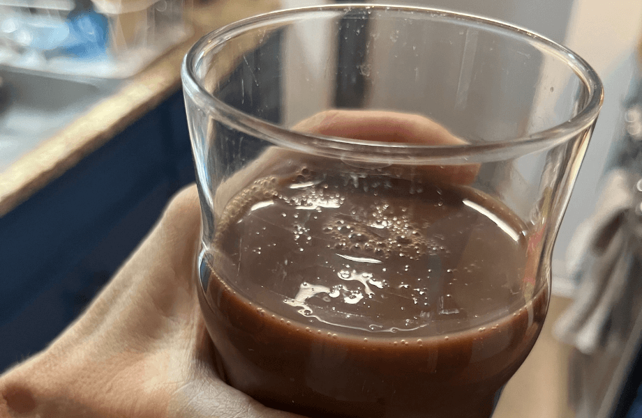 Our tester holding a glass of Muscle Milk Zero Protein Shake