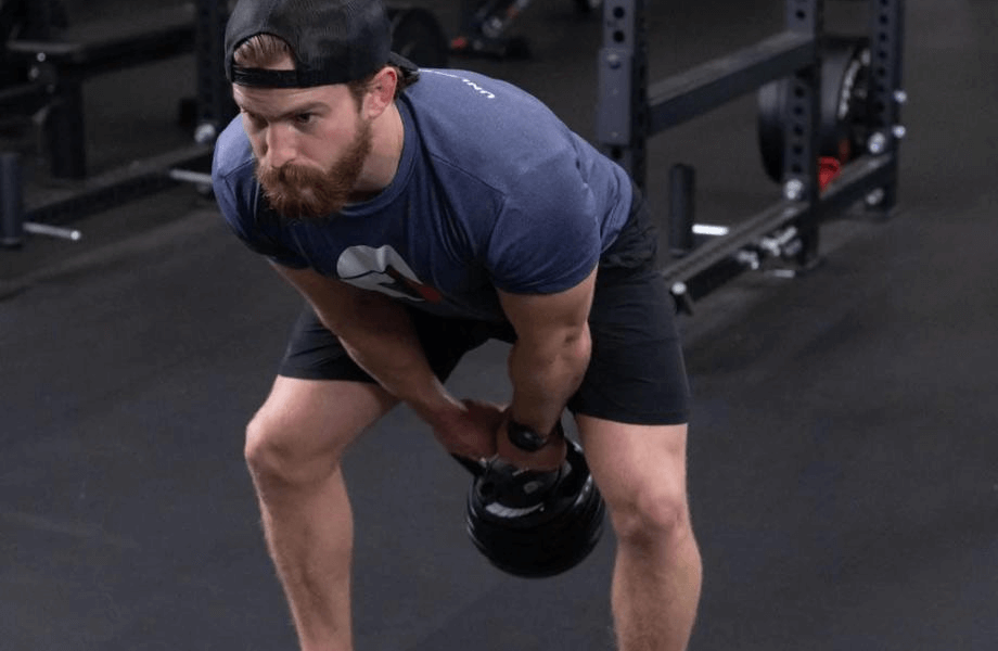 Man performing a kettlebell swing with the Titan Fitness Adjustable Kettlebell