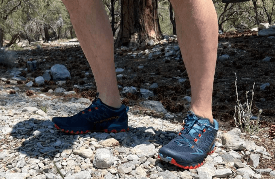 Our tester wearing La Sportiva Bushido III trail running shoes on a rocky pathway