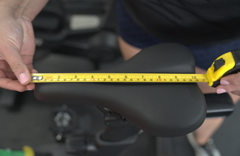 Our tester measuring the seat on a Nordictrack X24 Bike