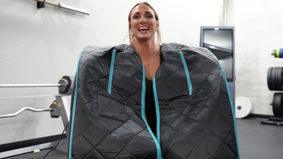 A woman with her head out of an unzipped Smartmak Far Infrared Sauna