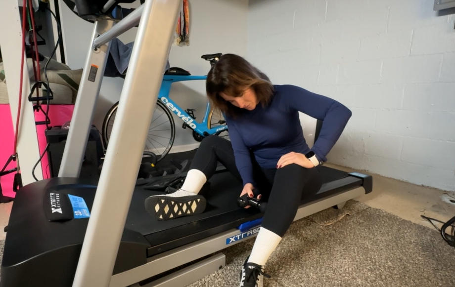 A woman uses the Bob & Brad Q2 Mini Pro on her calf muscles.