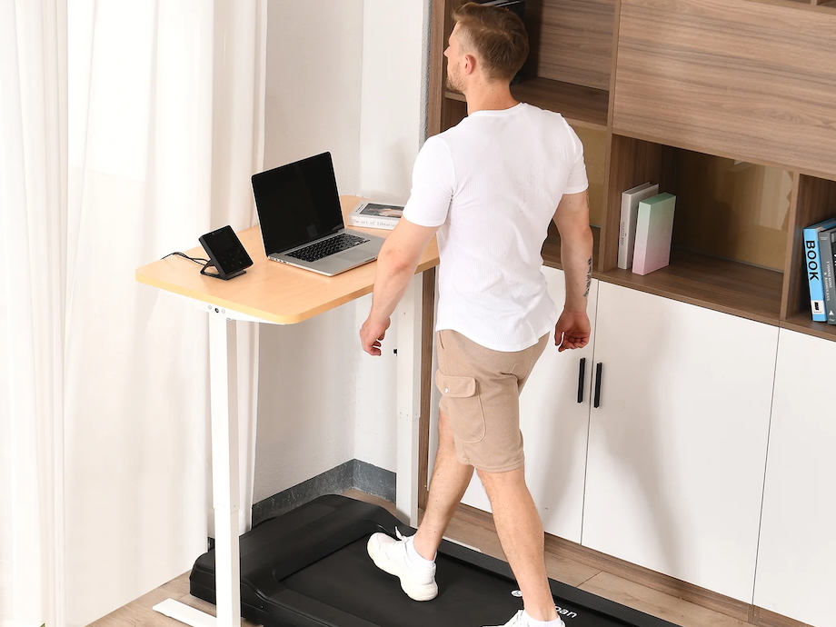 A man is shown walking on a LifeSpan TR1200 treadmill.