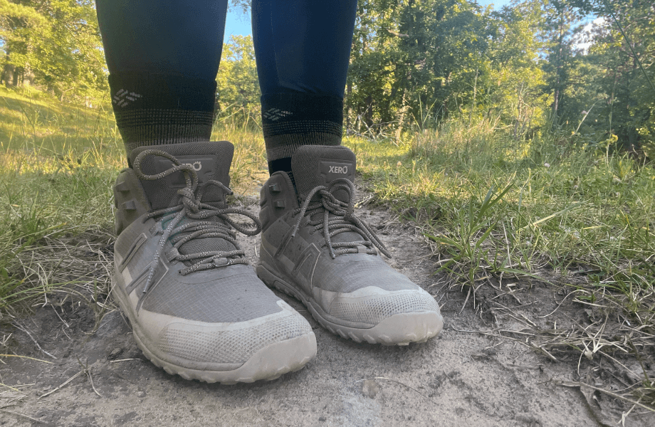 Our tester wearing Xero Shoes Scrambler Trails on a dirt-caked trailway