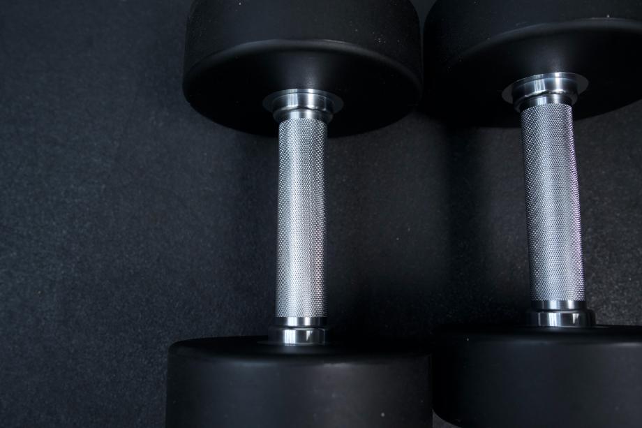 A close look at the knurling on a pair of Rogue Urethane Dumbbells.