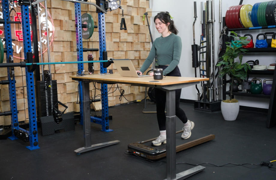A woman walking on a UREVO SpaceWalk E4W Smart Walking Pad treadmill.