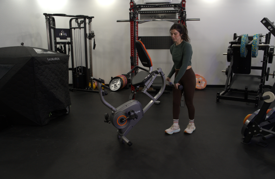 Our tester moving the YOSUDA Recumbent Exercise Bike into position for a workout session