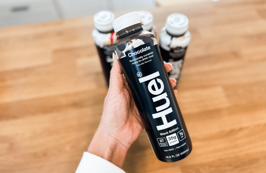 Our tester holding a bottle of Huel Ready-to-Drink Chocolate meal replacement shake