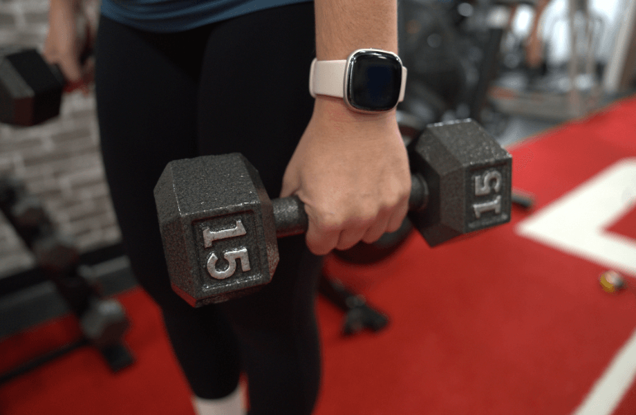 Our tester holding a 15-pound CAP Cast Iron Hex Dumbbell
