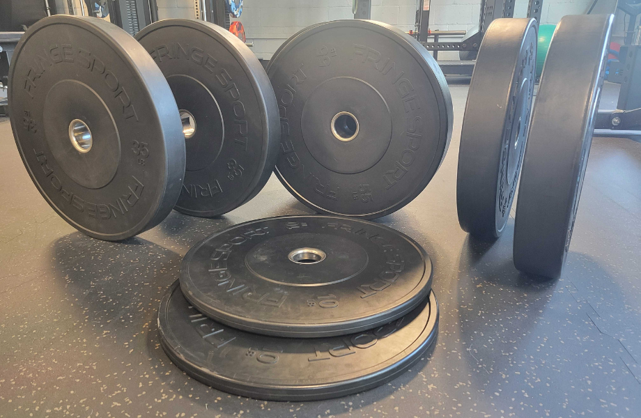 An assortment of Fringe Sport Black Bumper Plates