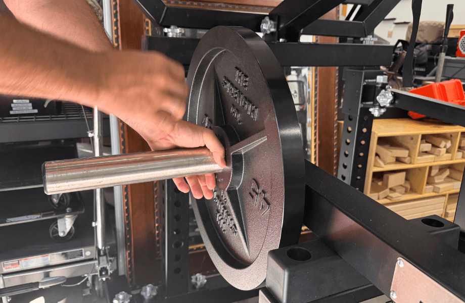 Our tester adding weight plates to the Quantum Free Trainer