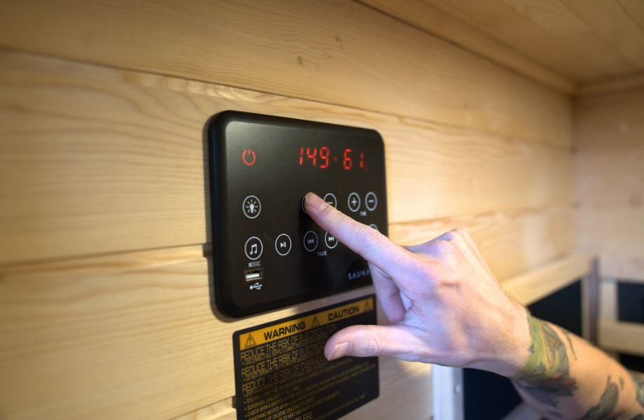 Our tester adjusting the SaunaBox Solara's settings
