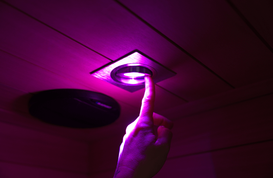 Our tester adjusting the chromotherapy lighting found in the Sun Home Equinox infrared sauna