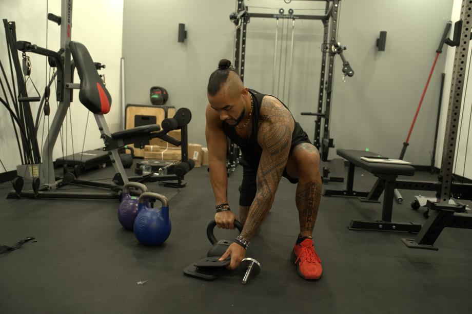 Stephen Sheehan, CPT, CNC, setting up an Ironmaster Quick-Lock Adjustable Kettlebell