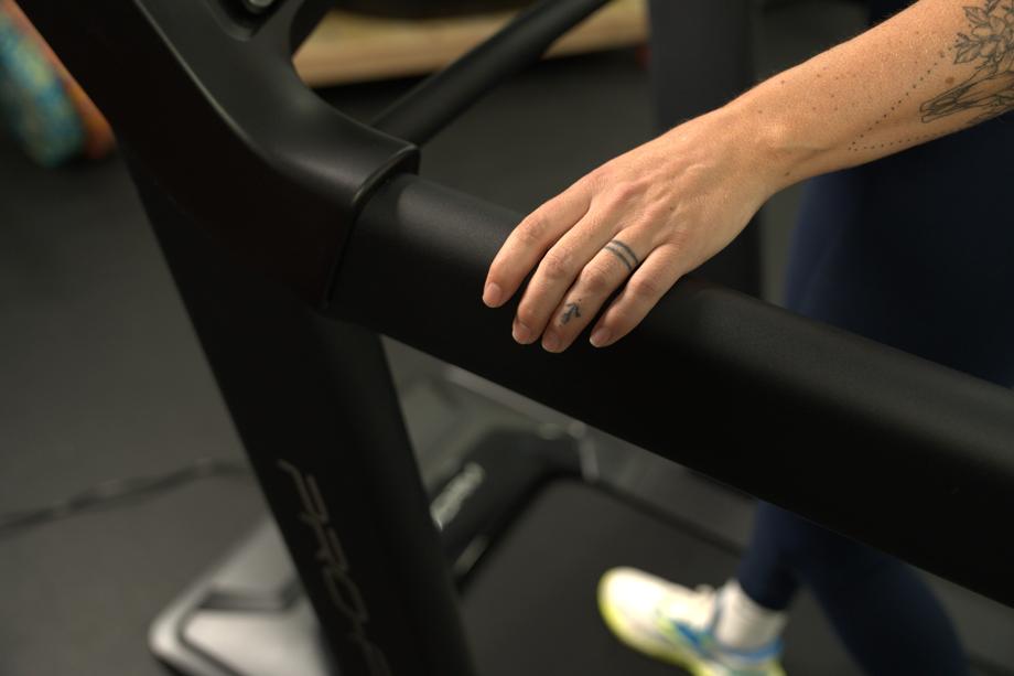 Lindsay Scheele holds the side handrail on a ProForm Carbon Pro 2000 treadmill.
