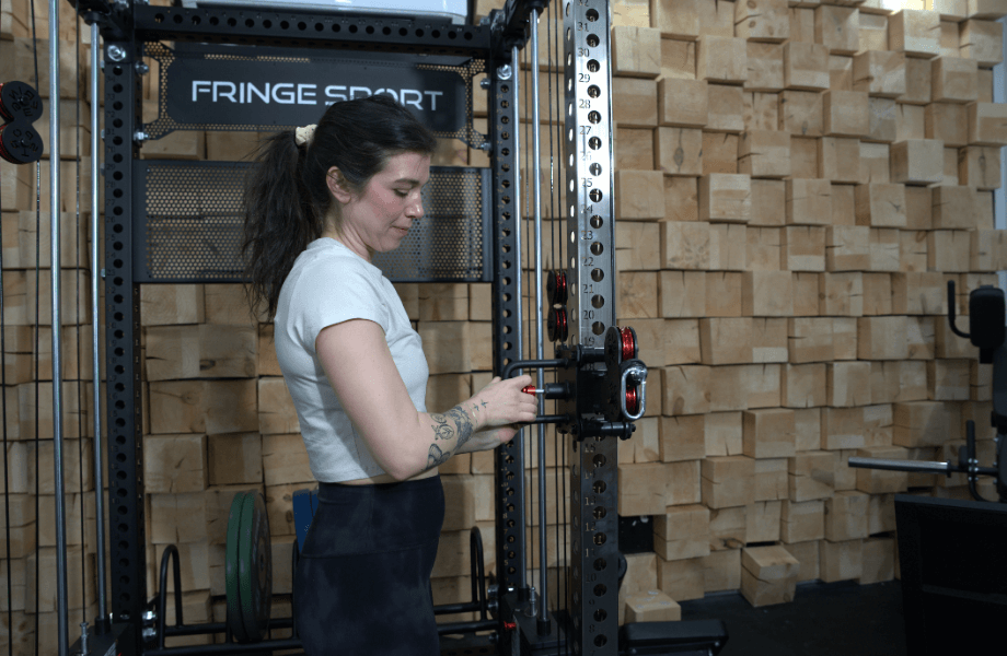 Our tester adjusting one of the Fringe Sport Dane 2.0's cable pulleys to their preferred height