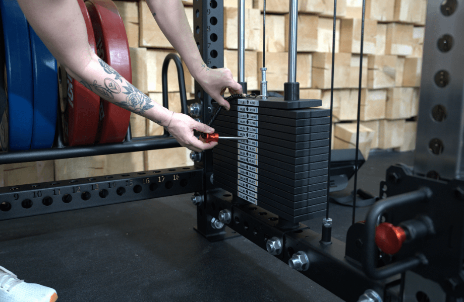 Our tester adjusting the weight stack on the Fringe Sport Dane 2.0 functional trainer