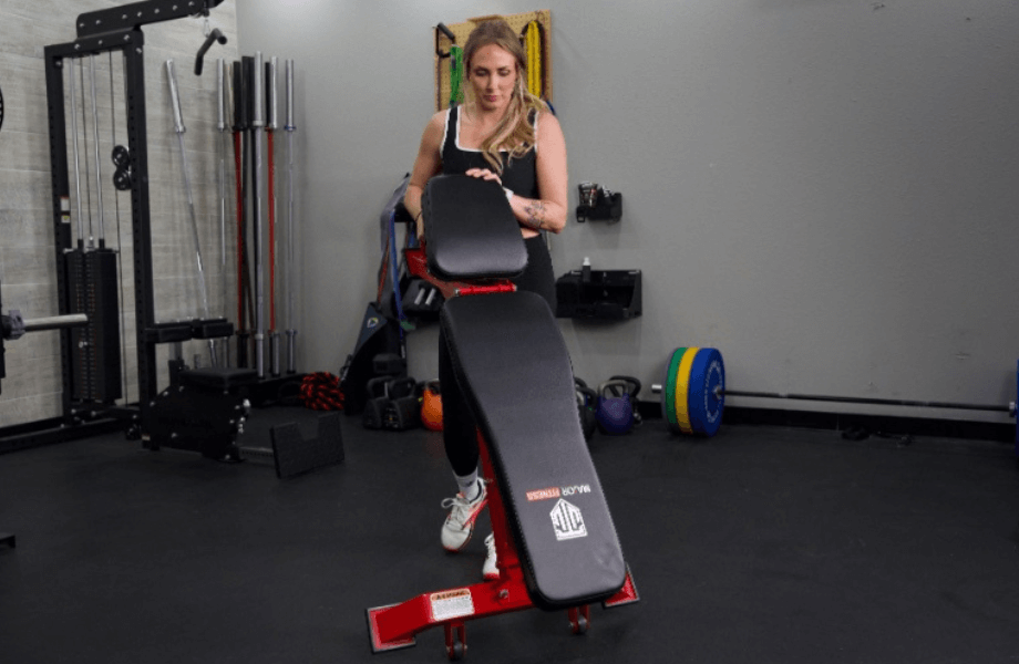 Our tester moving the Major Fitness Adjustable Bench into position for a training session