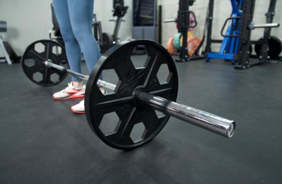 A Major Fitness Barbell at a person's feet